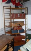 A 1970's retro Ladderax wall system comprising upright stands with modular corner shelves all with