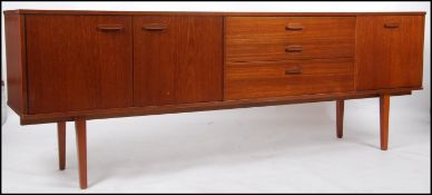 A 1970's Avalon teak sideboard of good proportions being raised on turned legs with a central bank