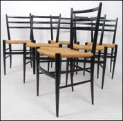 A set of 6 mid century ebonised and rattan weave dining chairs in the manner of Gio Ponti.