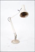 A vintage post war Herbert Terry anglepoise desk lamp raised on circular base with pendant shade