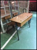 A large double school desk of French origin having tubular metal frame with slatted seat and hinged