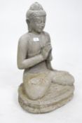 A large weathered carved seated buddha of Balinese origin constructed of reconstituted stone.
