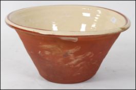 A large cream and terracotta part glazed mid century dairy crock dough bowl -mixing bowl having