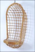 A 1970's hanging / swing egg chair having rattan weave construction to a wire work frame.