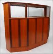 A good 1970's retro teak wood Danish influence cocktail drinks bar having glass display shelf over