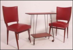 A 1950's mid century Red Formica and hairpin leg bridge table together with 2 red vinyl and beech
