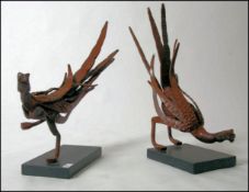 A pair of bespoke designed pheasants, hot forged from rolled steel on a thick granite base.