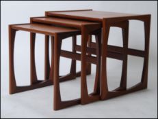 A 1970's G-Plan Kelso pattern retro teak wood nest of tables raised on shaped supports with