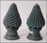 An unusual 1970's pair of ceramic lights of tapering two part form having ball finish over circular
