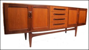 A good retro 1970's long and low G plan Fresco teak sideboard enclosed by moulded panelled door