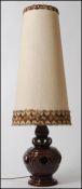 A large 1970's West German fat lava type table lamp having large conical shade in fully working