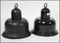 A pair of Industrial 20th century black and white enamel factory pendant shades of unusual shape