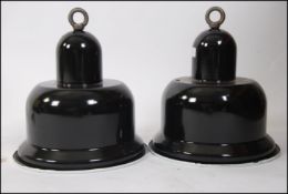 A pair of Industrial 20th century black and white enamel factory pendant shades of unusual shape