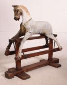 A good early 19th century wooden rocking horse with plaster finish retaining some original