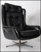 A 1970's retro black and leather chrome swivel chair.
