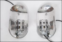 A pair of Industrial polished aluminium minimalist wall lights having lozenge back plates with