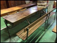 A large double school desk of French origin having tubular metal frame with slatted seat and hinged
