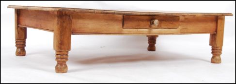 A Victorian pine low and wide coffee table being raised on turned legs with planked top ( converted