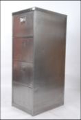 A polished steel mid century Industrial factory pedestal office 4 drawer filing cabinet.