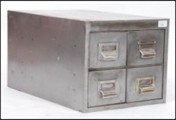 A polished steel mid century Industrial factory 4 drawer desk top filing index cabinet.