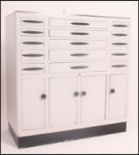 A 1950's mid century dentists cabinet having sectional metal body comprising a series of drawers
