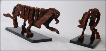 A pair of bespoke designed Spaniel type dogs, hot forged from rolled steel on a thick granite base.