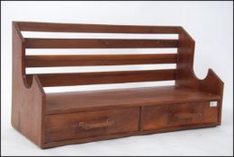 An unusual mid century solid walnut wall rack cabinet.