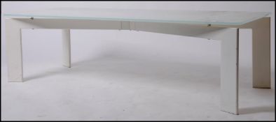 A 20th century modernist coffee - occasional table raised on shaped metal base painted white (