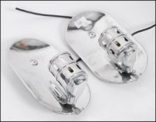A pair of Industrial polished aluminium minimalist wall lights having lozenge back plates with