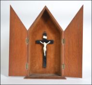 A 20th Century wooden crucifix cabinet c