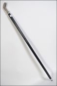 An ebonised walking cane with a silver p