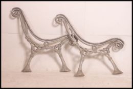 A pair of cast metal bench ends dating f