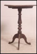 A 19th century tilt top wine table raised on splayed legs with turned column having square tilt top