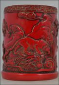 A cinnabar red Chinese brush pot depicti