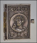 A miniature silver plated covered bookle