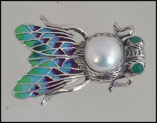 A silver 925 plique-a-jour brooch in the