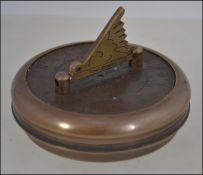 A brass cased compass and sundial stampe