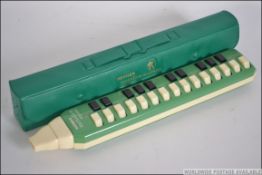 An little used retro Hohner Melodica - Soprano in green with the original case and instructions.