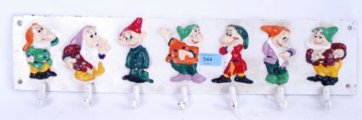A cast iron Snow White Disney style coat rack. Each dwarf hand painted.