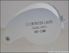 A modern jewellers loupe with swivel glass action with built in light