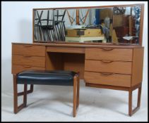 A 1970's Europa teak dressing table with a bank of drawers having long mirror atop in the manner of