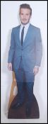 A life size advertising cardboard cut out of David Beckham dressed in a suit advertising David