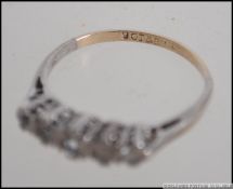 A 9ct gold ladies jewellery ring, with 6x clear stones, mounted in silver.