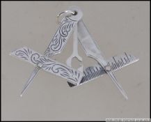A silver Masonic symbol with rule and compass. Weight 5.