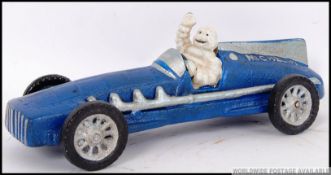 A vintage style, advertising cast iron blue racing car being driven by the Michelin Man. 28cm long.