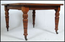 A good Victorian extending winding mahogany dining table on reeded tapering legs and castors,