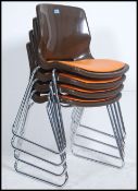 A set of four retro Herman Miller style chrome and plastic stacking chairs.