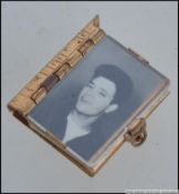 An unusual gilt metal mid century miniature book with clasp having fold out pictorials of Elvis,