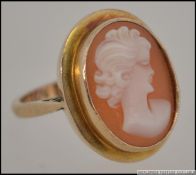 A mid century 9ct gold cameo ring with oval set maiden. The ring marked for Birmingham 1965.