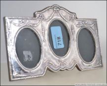 A silver hallmarked Adams revival triptych - triple picture frame with wooden back and easel